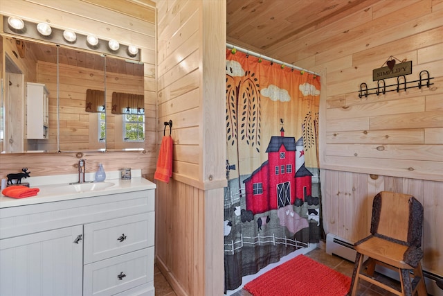 bathroom with wood walls, vanity, and a baseboard radiator