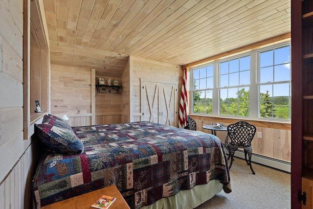 carpeted bedroom featuring baseboard heating, wooden ceiling, and wood walls