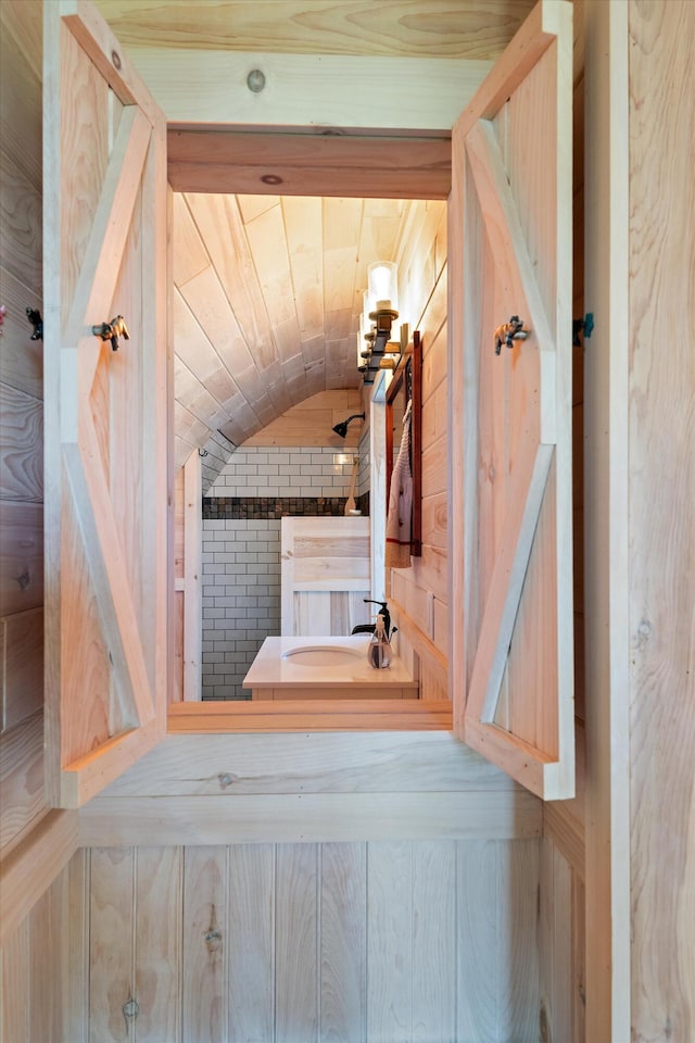 bathroom with sink and vaulted ceiling