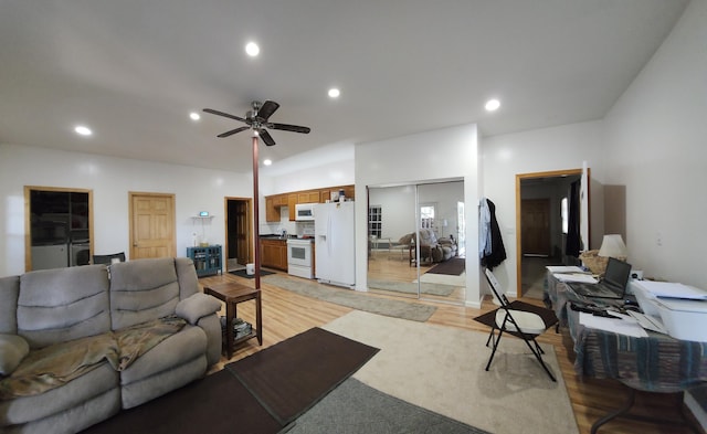 living room featuring ceiling fan and light hardwood / wood-style flooring