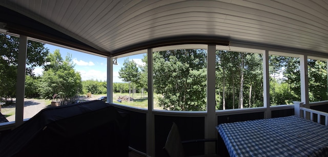 unfurnished sunroom with vaulted ceiling