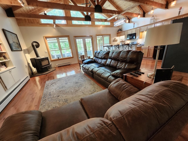 living room featuring a baseboard heating unit, beamed ceiling, wood ceiling, a wood stove, and high vaulted ceiling