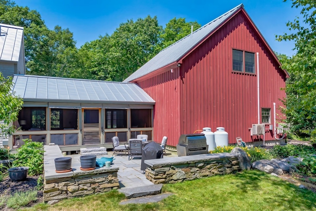226 Graytown Rd, Sedgwick, ME 04676 - rear view of house featuring a patio, metal roof, and a standing seam roof