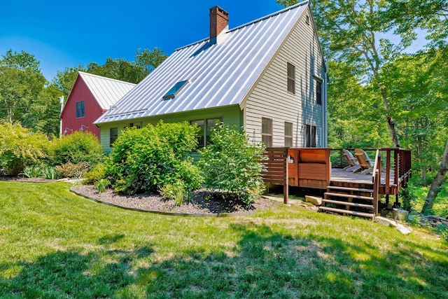 226 Graytown Rd, Sedgwick, ME 04676 - view of property exterior with metal roof, a chimney, a deck, and a yard