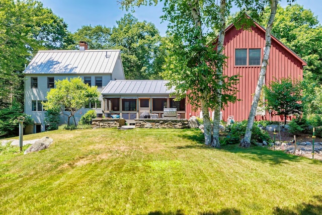 226 Graytown Rd, Sedgwick, ME 04676 - rear view of house with a standing seam roof, metal roof, a lawn, board and batten siding, and a chimney