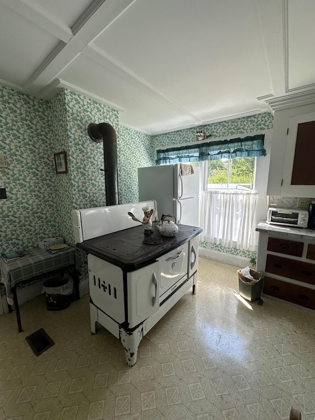 bedroom featuring white fridge and coffered ceiling