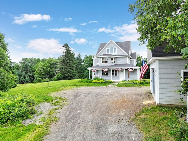 view of front of house with a porch and a front yard