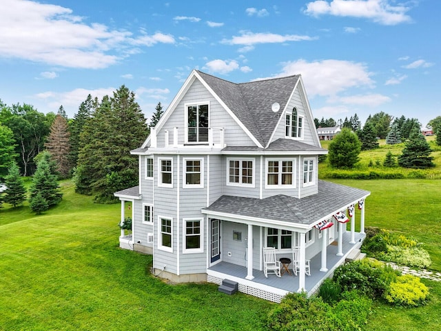 back of property featuring a lawn and a porch