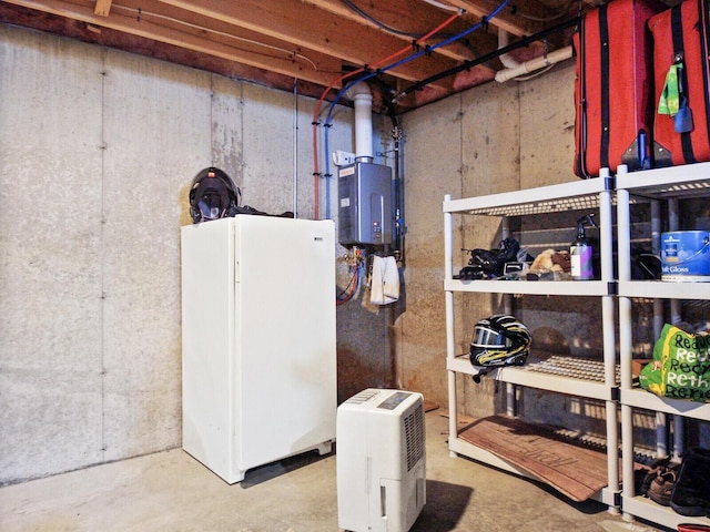 basement featuring white fridge and water heater