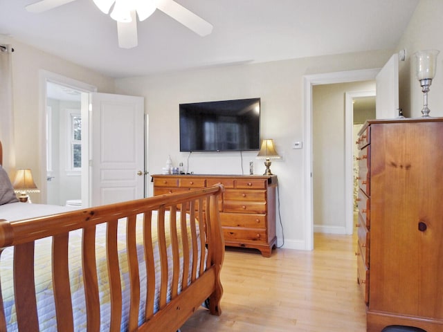 bedroom with connected bathroom, light hardwood / wood-style flooring, and ceiling fan