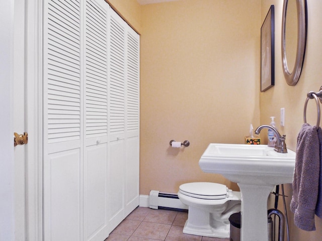 bathroom featuring baseboard heating, tile patterned floors, and toilet