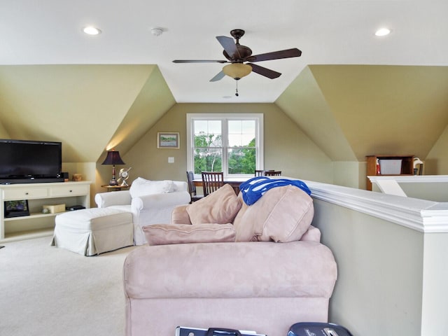 carpeted living room featuring ceiling fan and vaulted ceiling