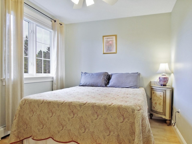 bedroom with ceiling fan and light wood-type flooring