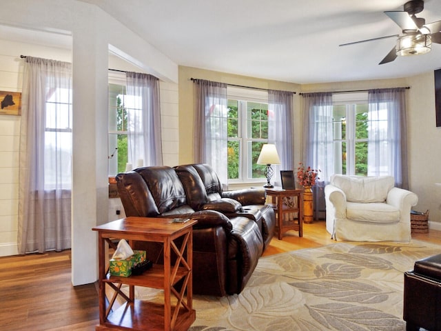 living room featuring hardwood / wood-style flooring and ceiling fan