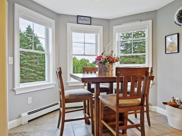 dining room with light tile patterned floors, a wealth of natural light, and a baseboard radiator