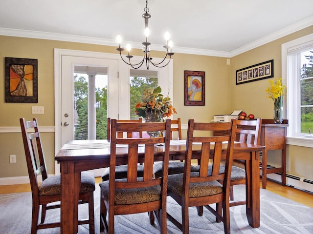 dining area featuring a chandelier, light wood-type flooring, a wealth of natural light, and ornamental molding