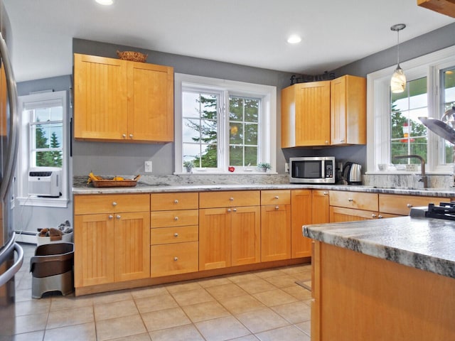 kitchen featuring pendant lighting, a healthy amount of sunlight, light tile patterned floors, and cooling unit