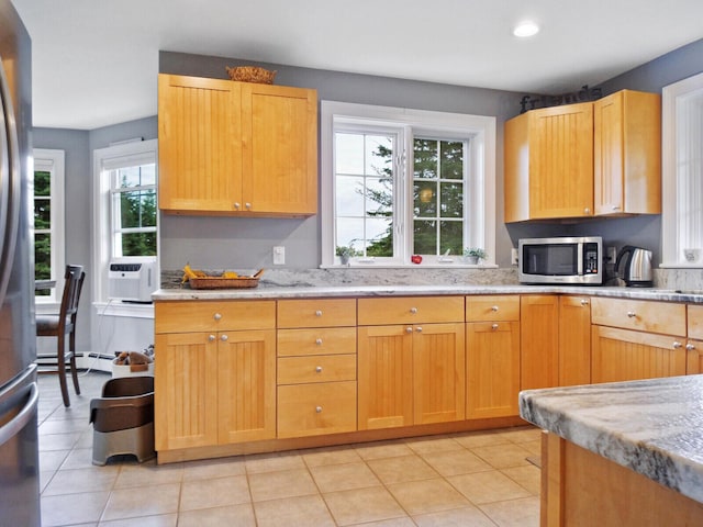 kitchen featuring light tile patterned flooring, light stone countertops, stainless steel appliances, and cooling unit