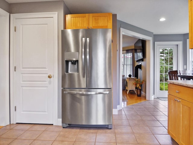 kitchen with stainless steel fridge and light tile patterned flooring