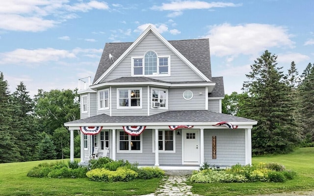 view of front of house with covered porch and a front yard