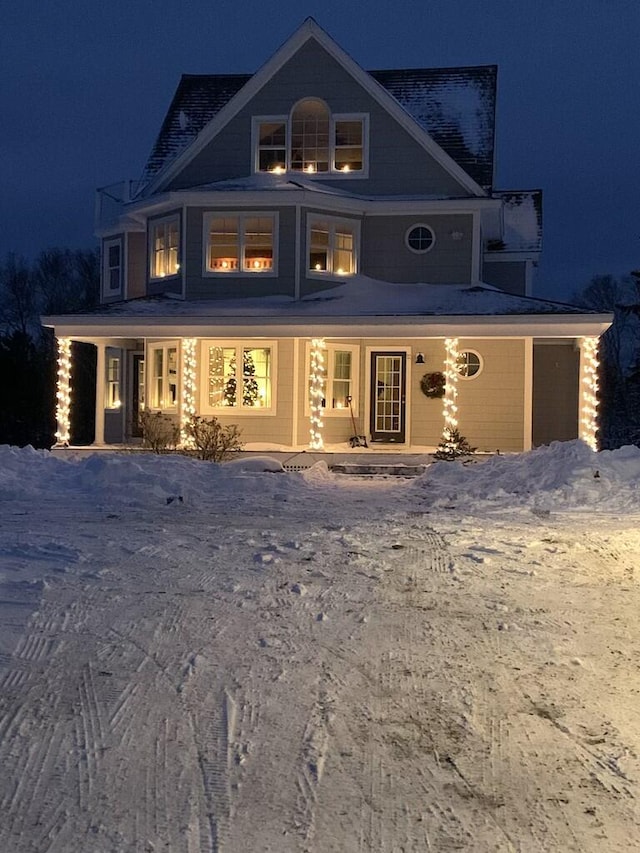 view of snow covered rear of property