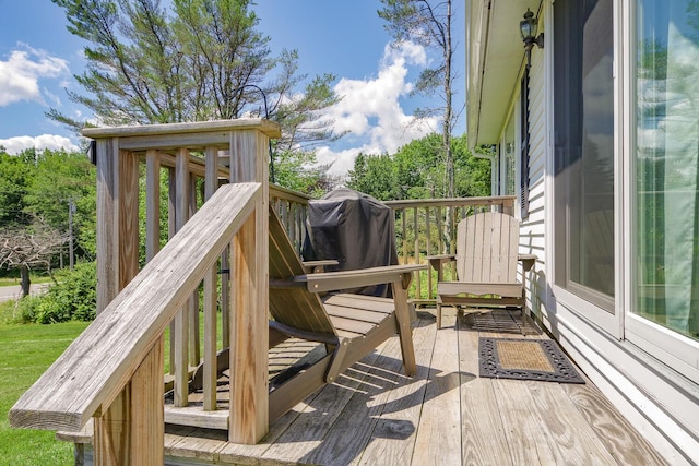 wooden terrace featuring a grill