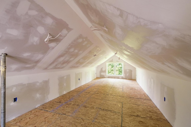 additional living space featuring lofted ceiling