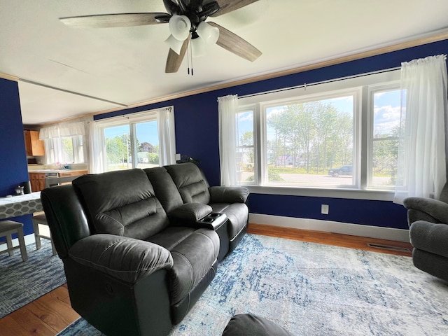 living room featuring ceiling fan and light hardwood / wood-style floors