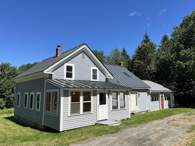 view of front of property with a garage and a front lawn