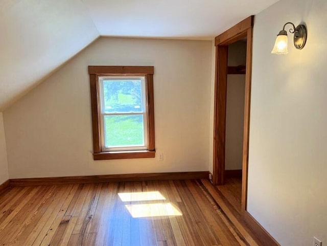 bonus room featuring vaulted ceiling and wood-type flooring