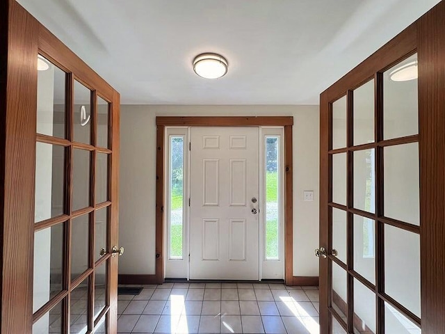 entrance foyer featuring light tile patterned floors and french doors