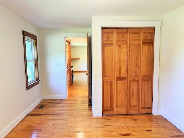 corridor with light hardwood / wood-style flooring