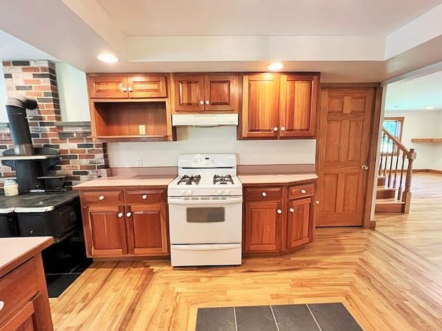 kitchen with light wood-type flooring and white gas range oven