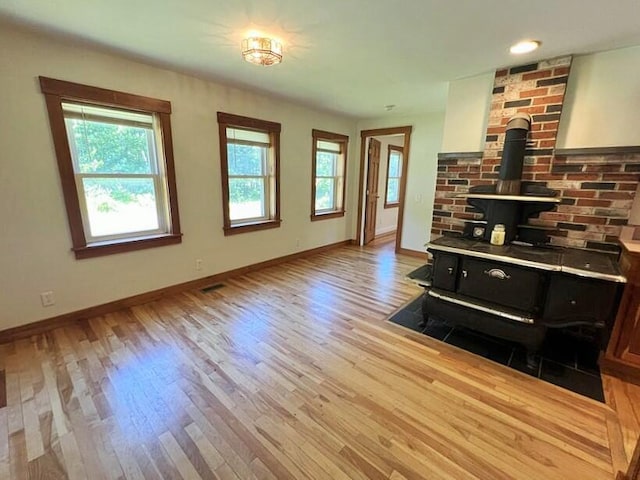 living room featuring light wood-type flooring and a wood stove