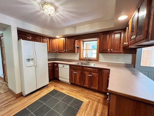 kitchen featuring light hardwood / wood-style floors, sink, and white appliances