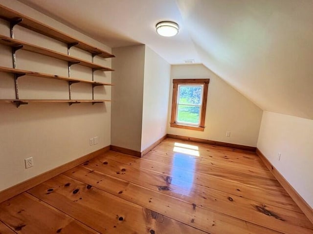 additional living space with lofted ceiling and light hardwood / wood-style floors