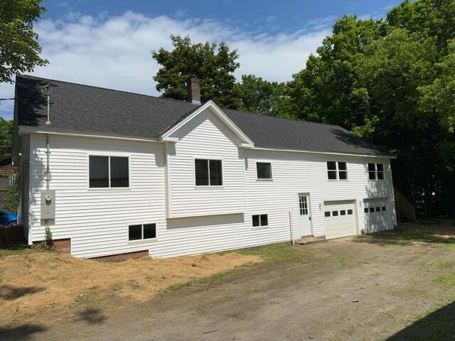 rear view of property with a garage