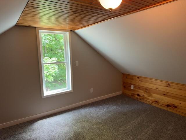 bonus room with lofted ceiling, wood ceiling, and carpet flooring