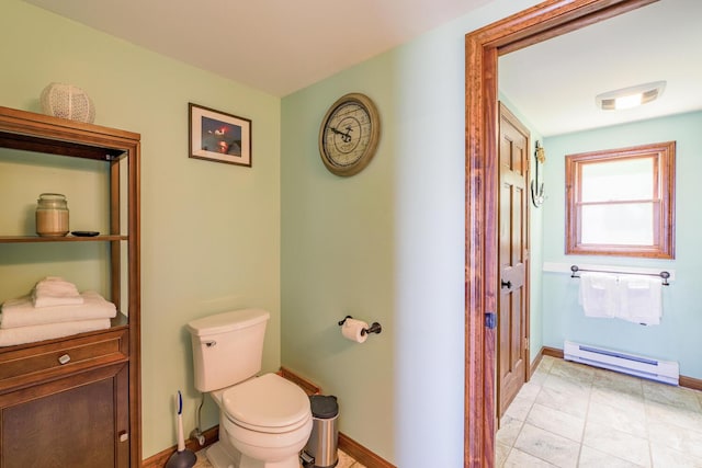 bathroom with visible vents, baseboard heating, toilet, and baseboards