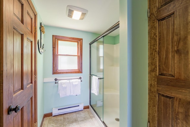 full bath with baseboards, baseboard heating, and a stall shower