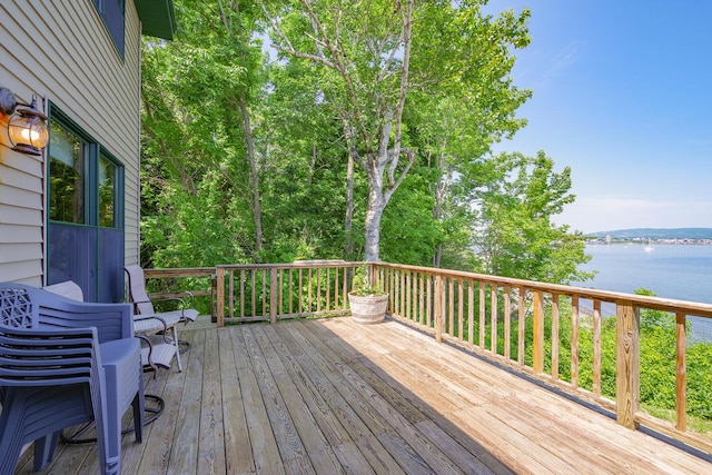 wooden terrace featuring a water view