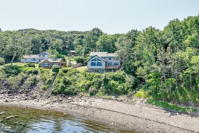 bird's eye view with a water view and a wooded view
