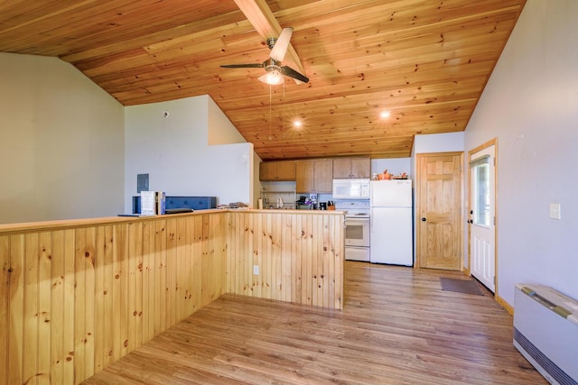 kitchen with a peninsula, white appliances, light wood-style flooring, and vaulted ceiling