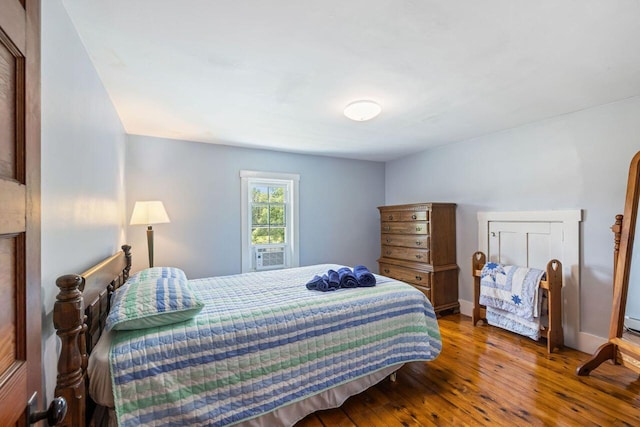 bedroom with hardwood / wood-style flooring