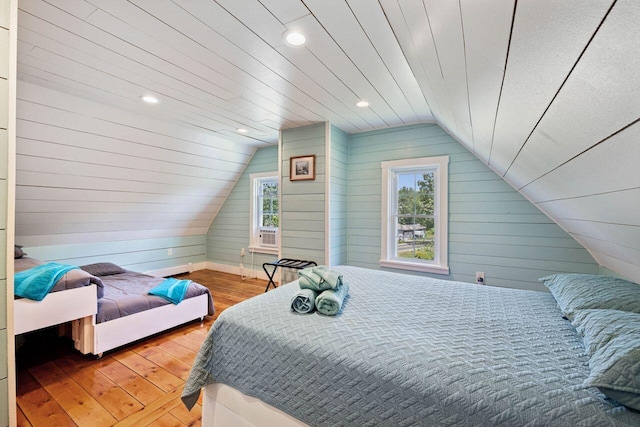 bedroom featuring hardwood / wood-style floors, vaulted ceiling, wood walls, and wood ceiling