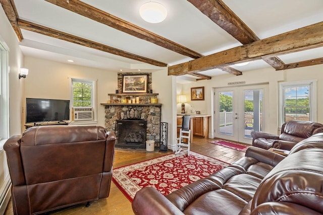 living room featuring beamed ceiling, plenty of natural light, a fireplace, and french doors