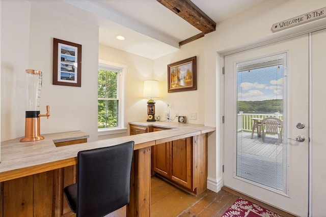 entryway featuring beamed ceiling and light hardwood / wood-style flooring