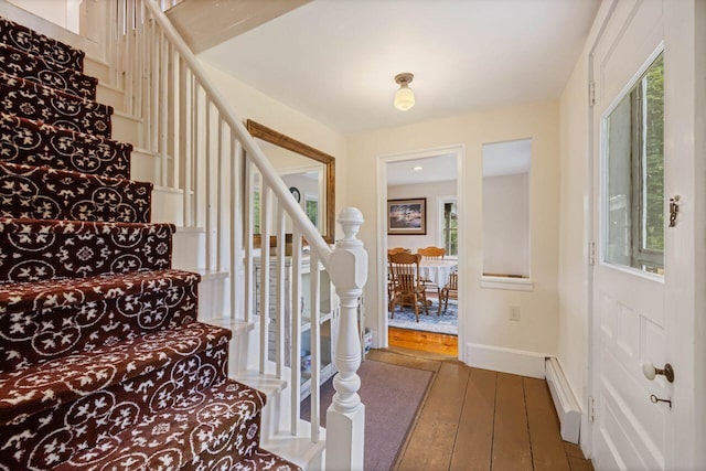 entrance foyer featuring dark hardwood / wood-style floors and a baseboard heating unit