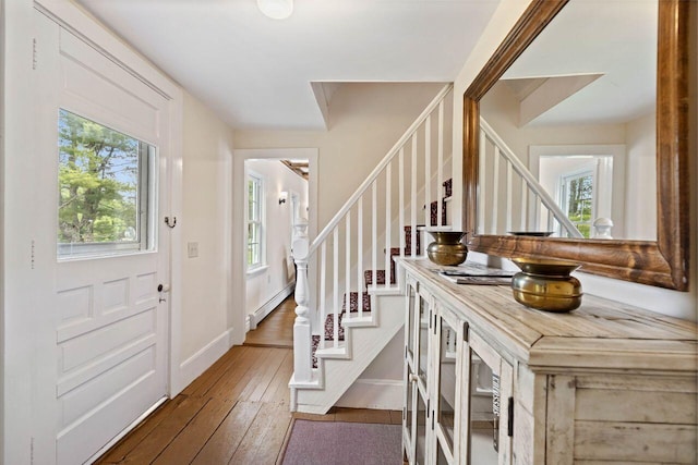 foyer entrance featuring dark hardwood / wood-style floors and baseboard heating