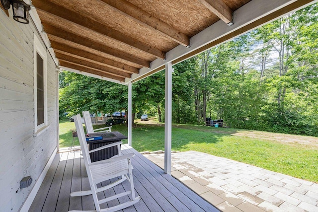 wooden terrace featuring a yard